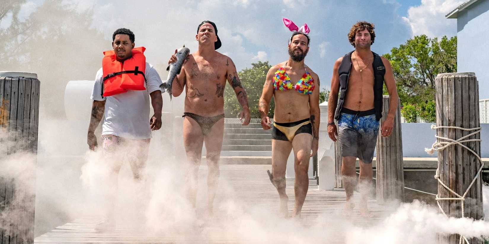 Jackass cast walking on to the beach for Shark Week