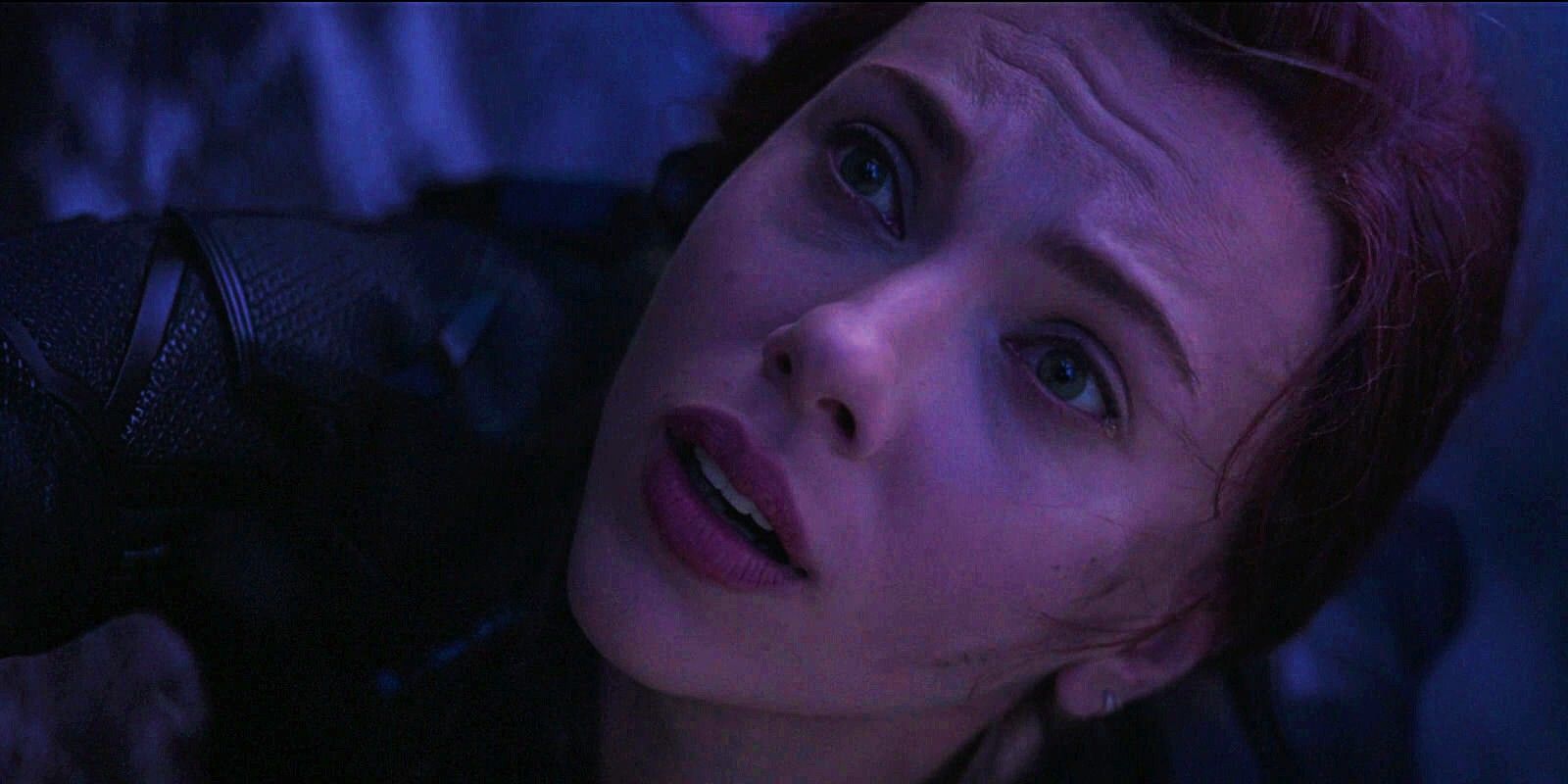 Natasha looks up as she hangs from the cliff on Vormir in Avengers: Endgame