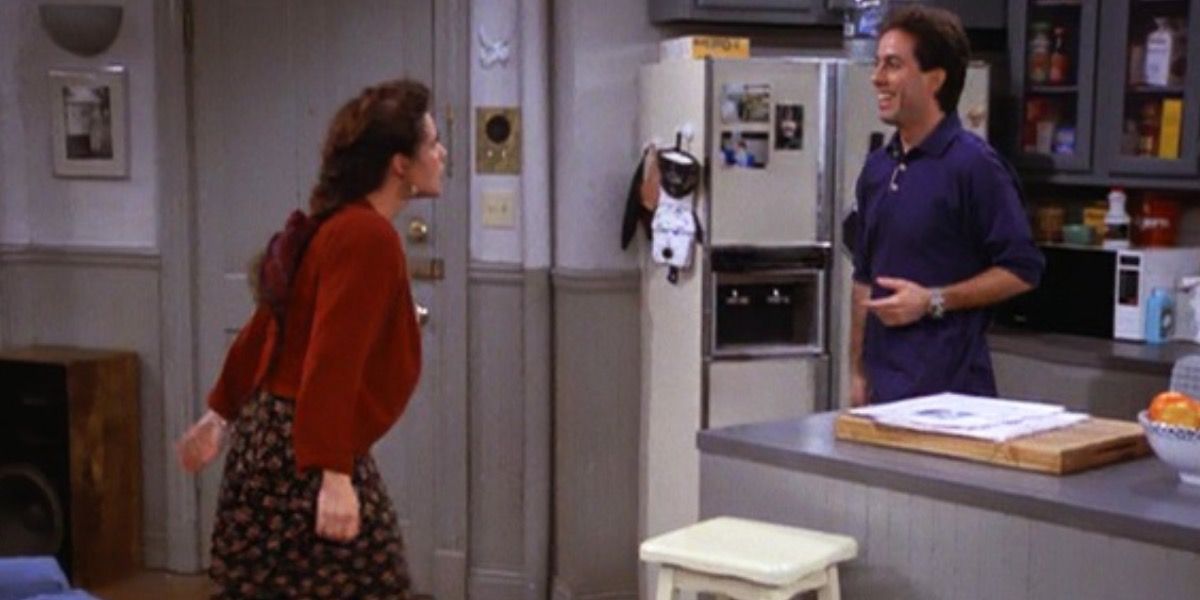Seinfeld Elaine about to shove Jerry into his kitchen