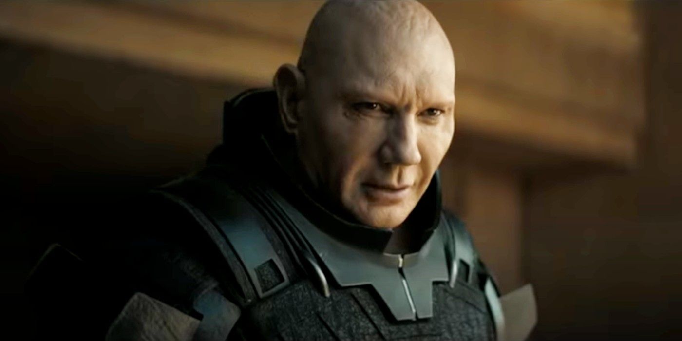 Dave Bautista as Glossu Rabban looking down at something in Dune