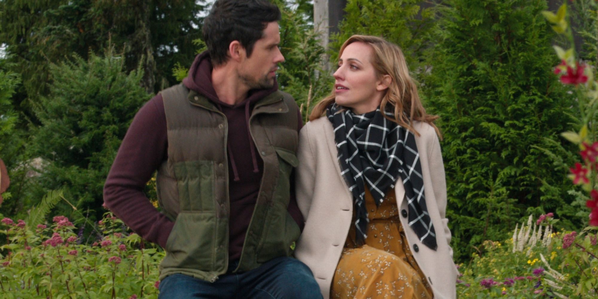 Brady and Brie sit next to each other and talk in Virgin River