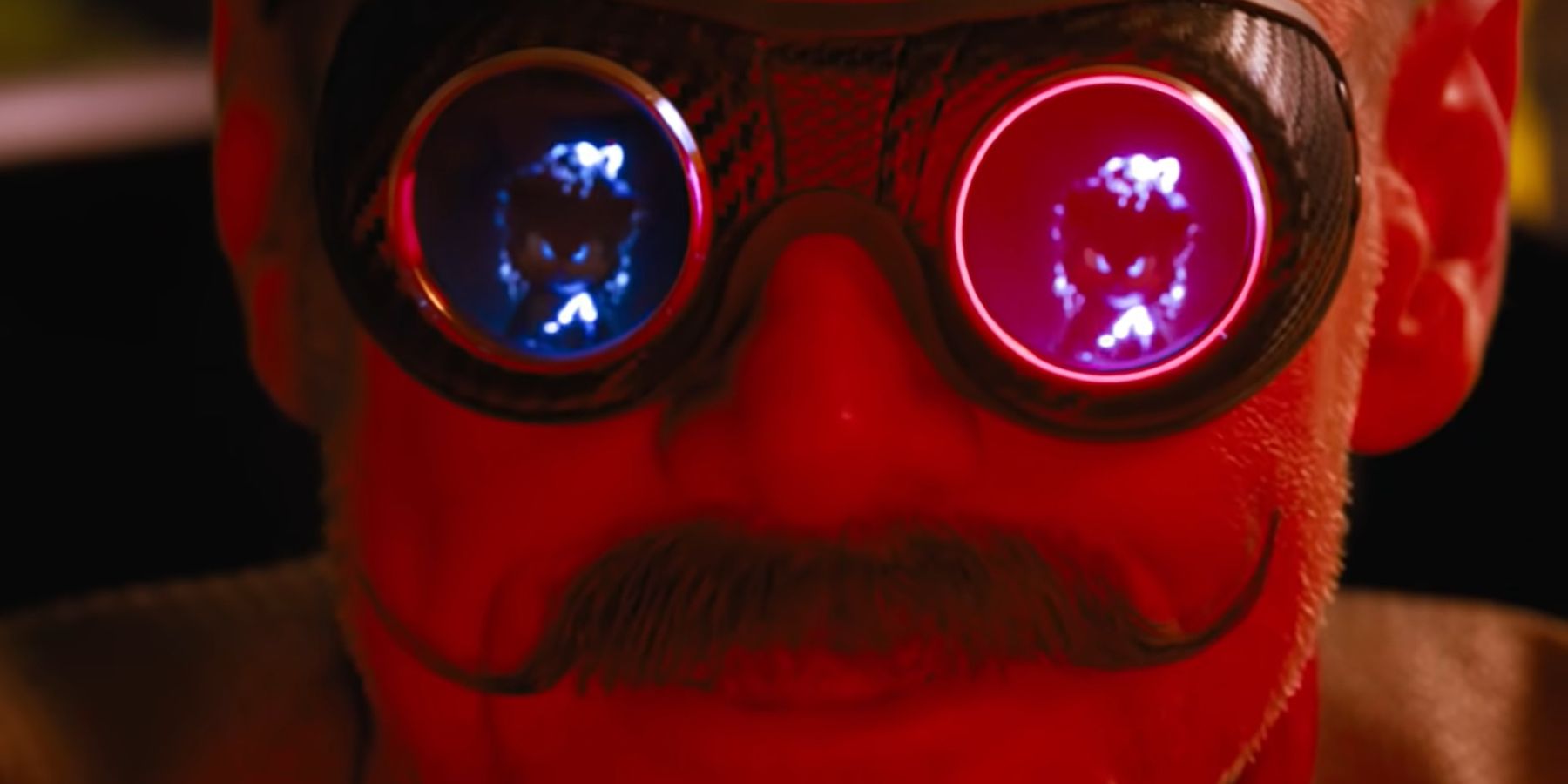 Dr Robotnik glaring at Sonic with Sonics reflection in the goggles in Sonic The Hedgehog