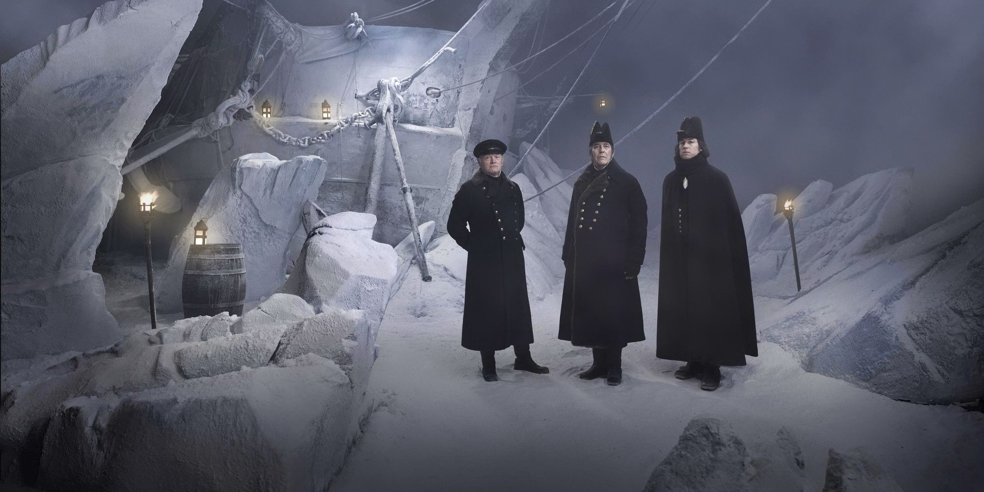 Three men in British naval uniforms stand on an ice floe with a wrecked ship behind them in a poster for The Terror season 1