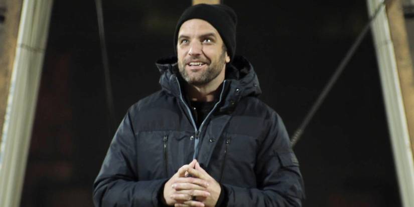TV Lavin clasps hands and wears a parka and beanie on The Challenge