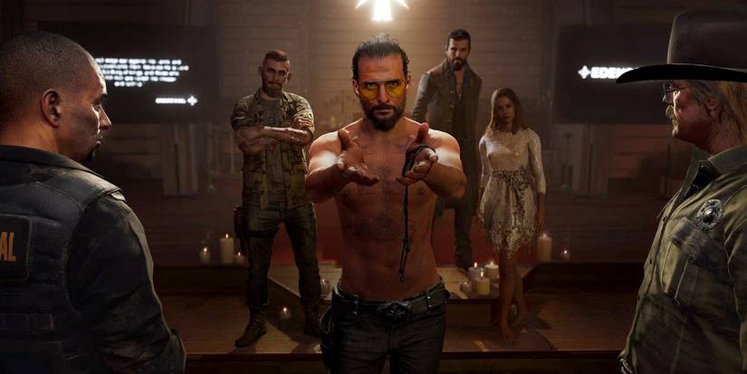 Joesph Seed with his hands out ready to be arrested in Far Cry 5.