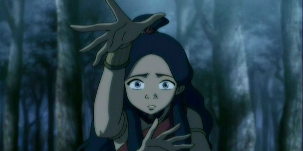 Katara from Avatar The Last Airbender looking scared in a dark forest