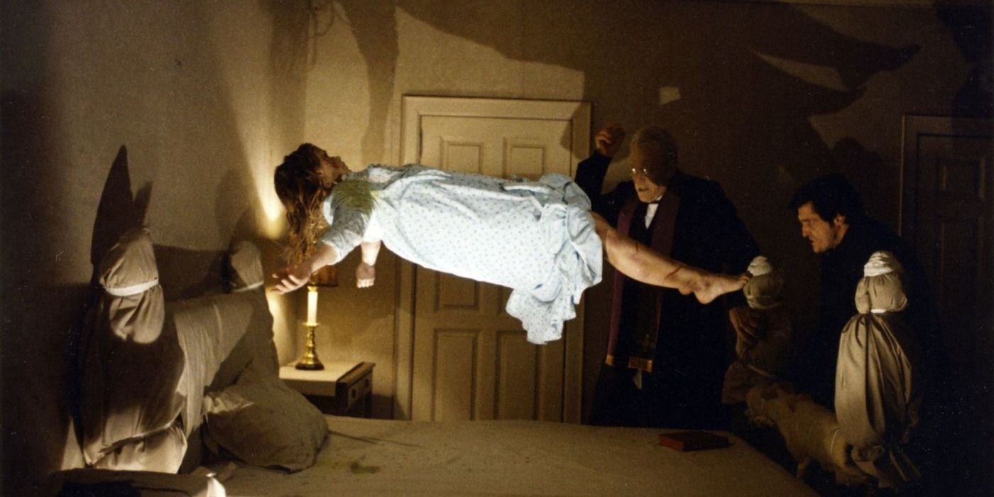The priests try to save Regan as she floats in The Exorcist