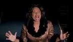 An overhead shot of Jennifer Hudson, singing passionately, hands out and eyes closed, from Dreamgirls.