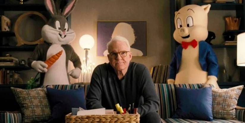 Bugs Bunny and Porky Pig stand behind Charles Haden Savage's couch in Only Murders in the Building