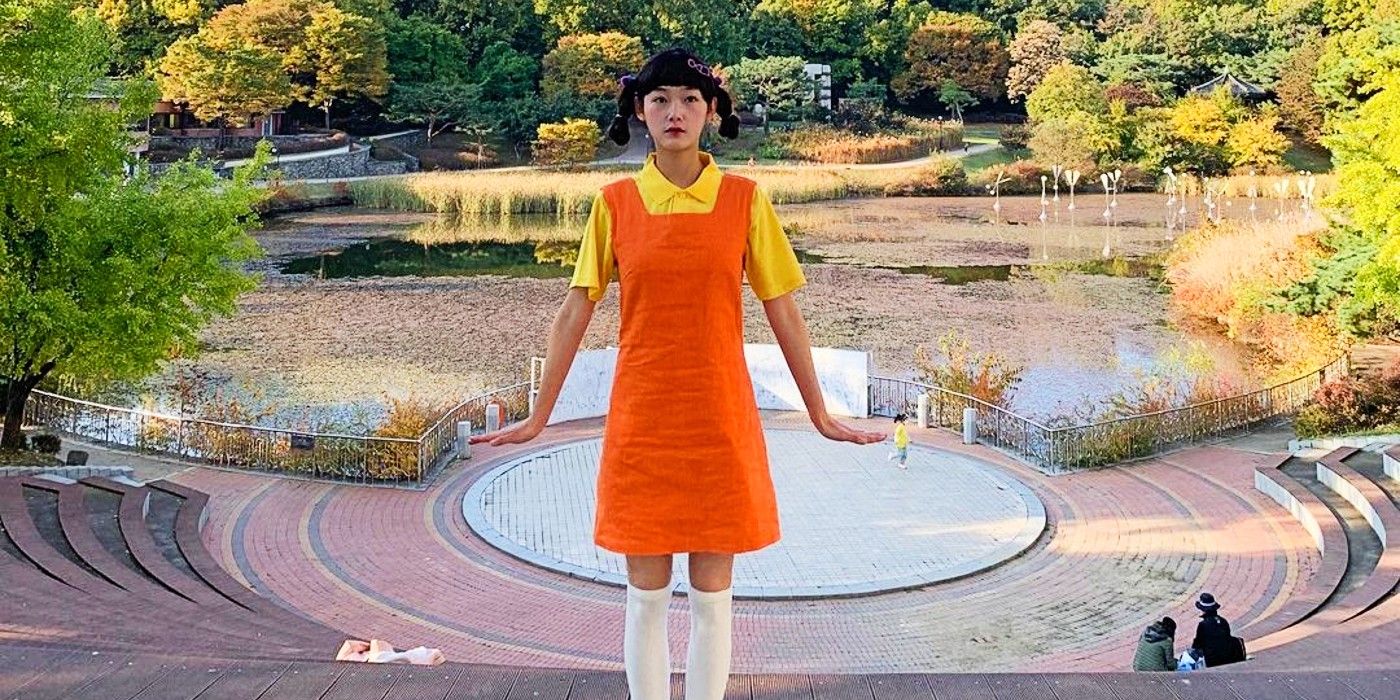 squid game doll orange dress SQUID GAME's Killer Doll Got a Scary Job: Door Greeter