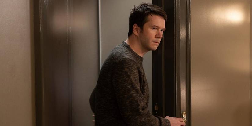 Theo Dimas standing in a doorway in Only Murders in the Building.