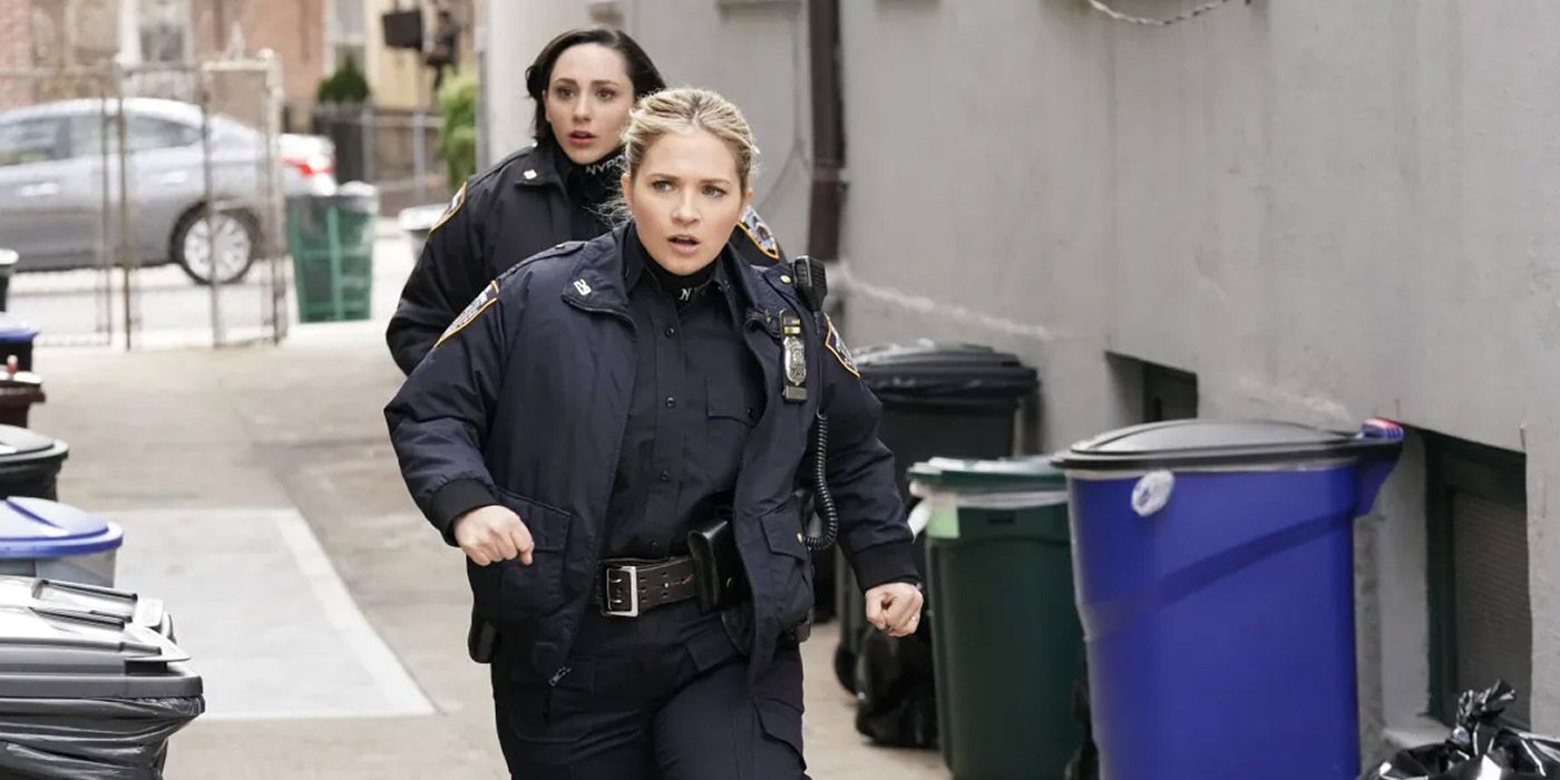 Eddie (Vanessa Ray) and her partner running into an alley in Blue Bloods