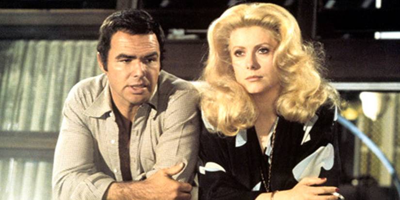 Burt Reynolds and Catherine Deneuve on a balcony in Hustle