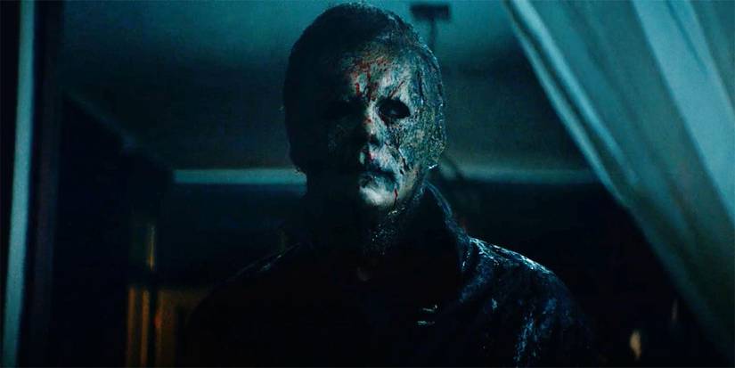 Michael Myers looking out the window in Halloween Kills.