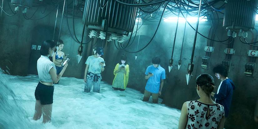 Arisu and other players standing in a room with water and electric rods in Alice in Borderland.