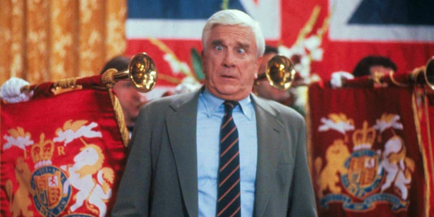 Leslie Nielsen looking disoriented in front of ceremonial trumpet players in The Naked GUn