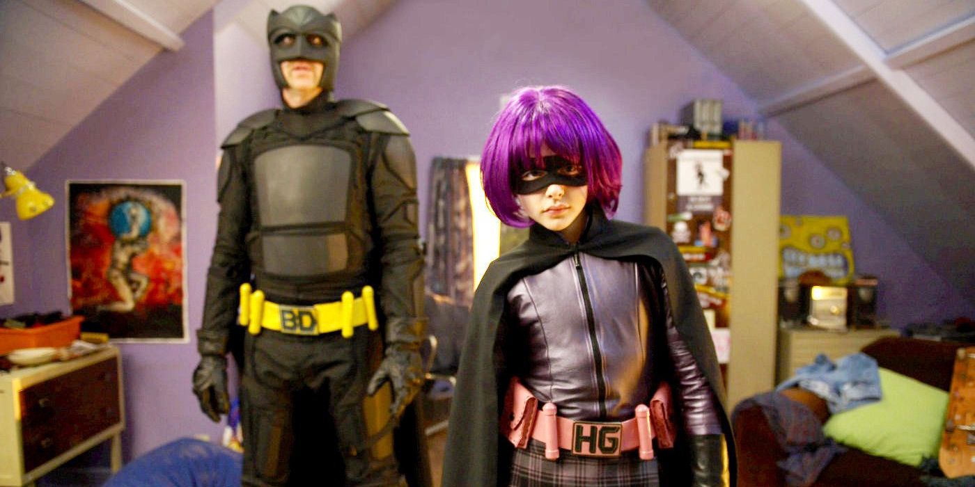 Big Daddy standing behind Hit Girl in Kick Ass