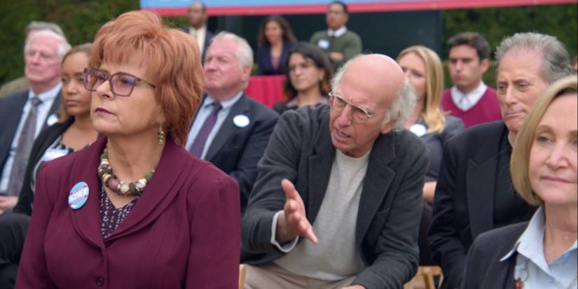 Larry pesters Irma at an election rally in Curb Your Enthusiasm