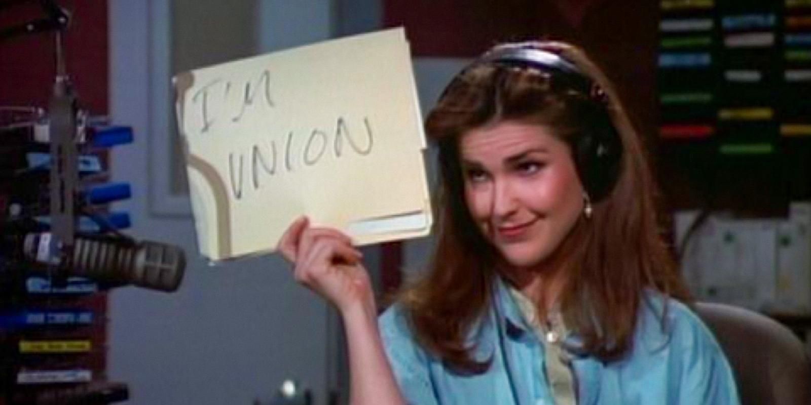 Roz Doyle holds up a sign saying Im union in Frasier
