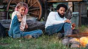 Teeter and Colby sit in the grass together on Yellowstone