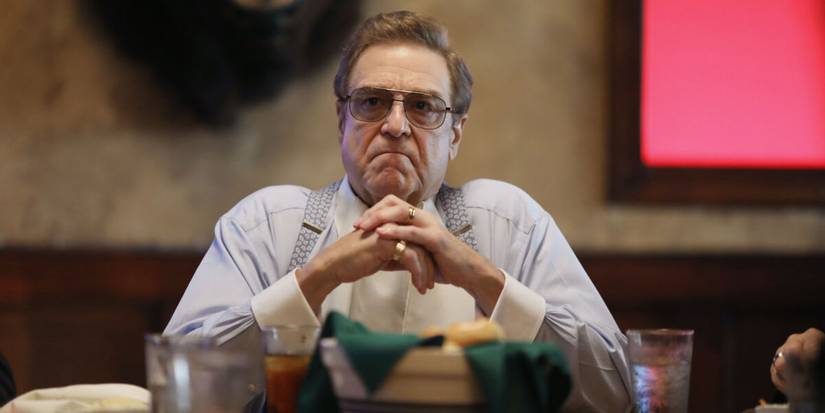 Dr Eli Gemstone sitting at his dining table in The Righteous Gemstones.