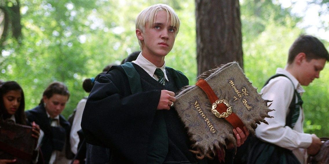 Draco Malfoy with a magical book in Harry Potter and the Prisoner of Azkaban Cropped