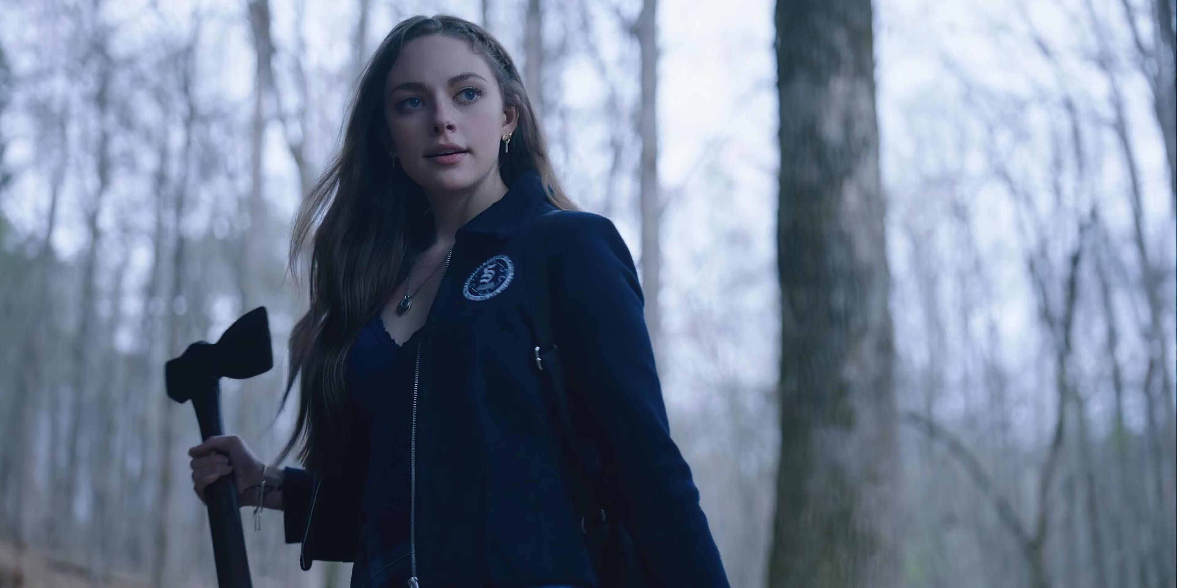 Hope Mikaelson holding in axe in the woods on Legacies