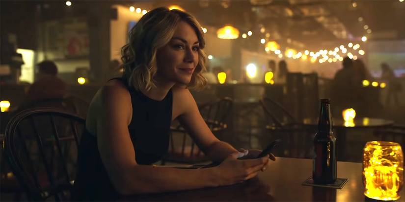 Jennifer Holland's Emilia Harcourt sits at a bar in Peacemaker