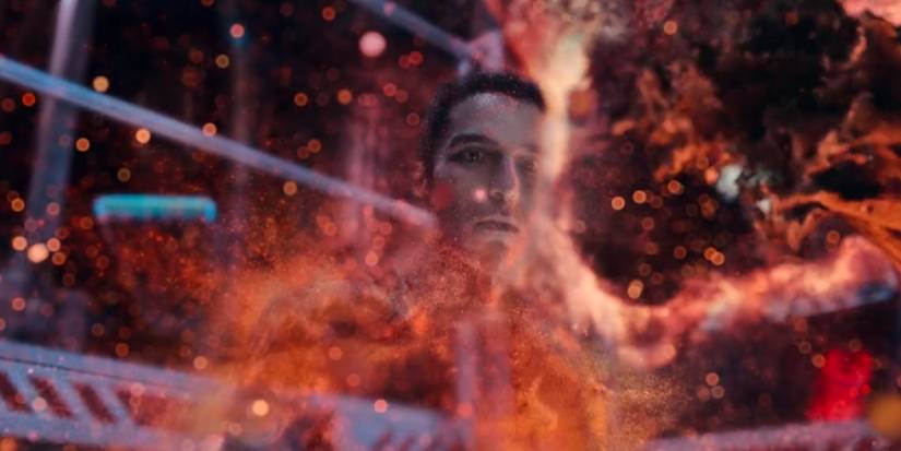 Marcos disappears into a red and orange dust.