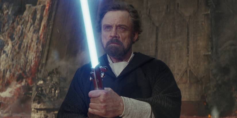 Luke Skywalker draws his lightsaber in The Last Jedi