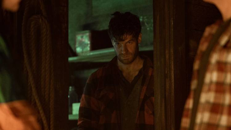 A man stands by the doorway in Yellowjackets.