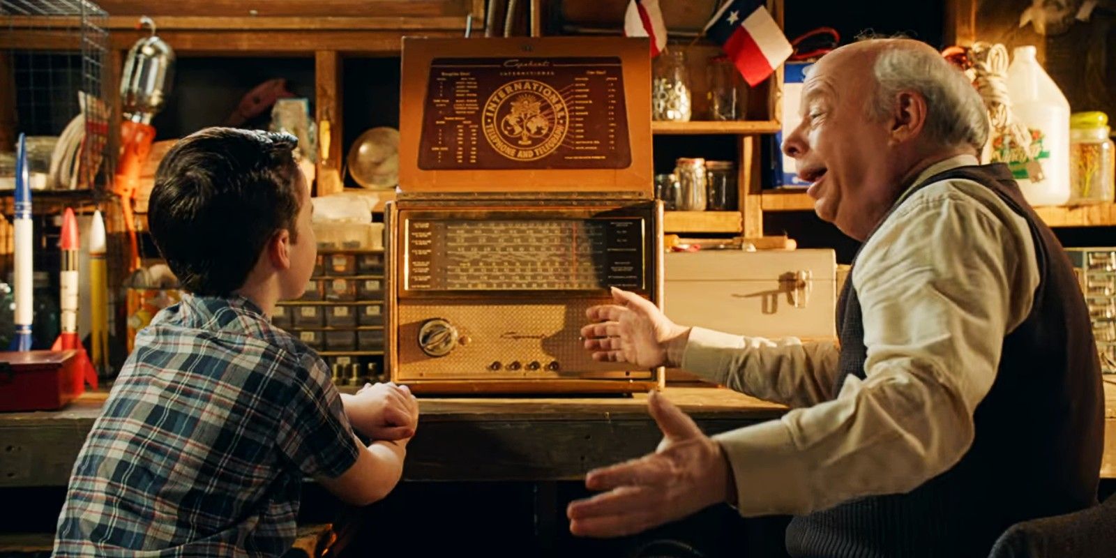 Iain Armitage's Sheldon and Wallace Shawn's Sturgis sit at a desk in Young Sheldon season 2 finale