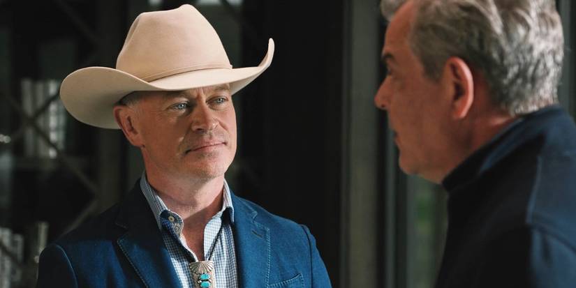 Malcolm Beck (Neal McDonough) smiling at Dan Jenkins (Danny Huston) in Yellowstone.