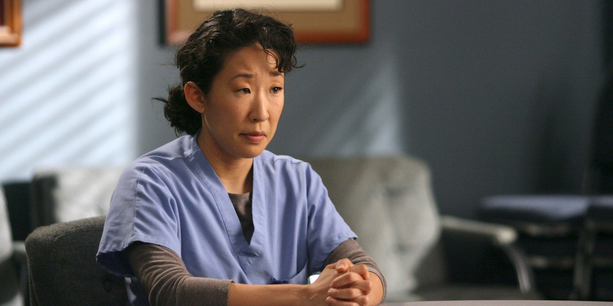 Cristina Yang with her hands together looking serious in Grey&rsquo;s Anatomy