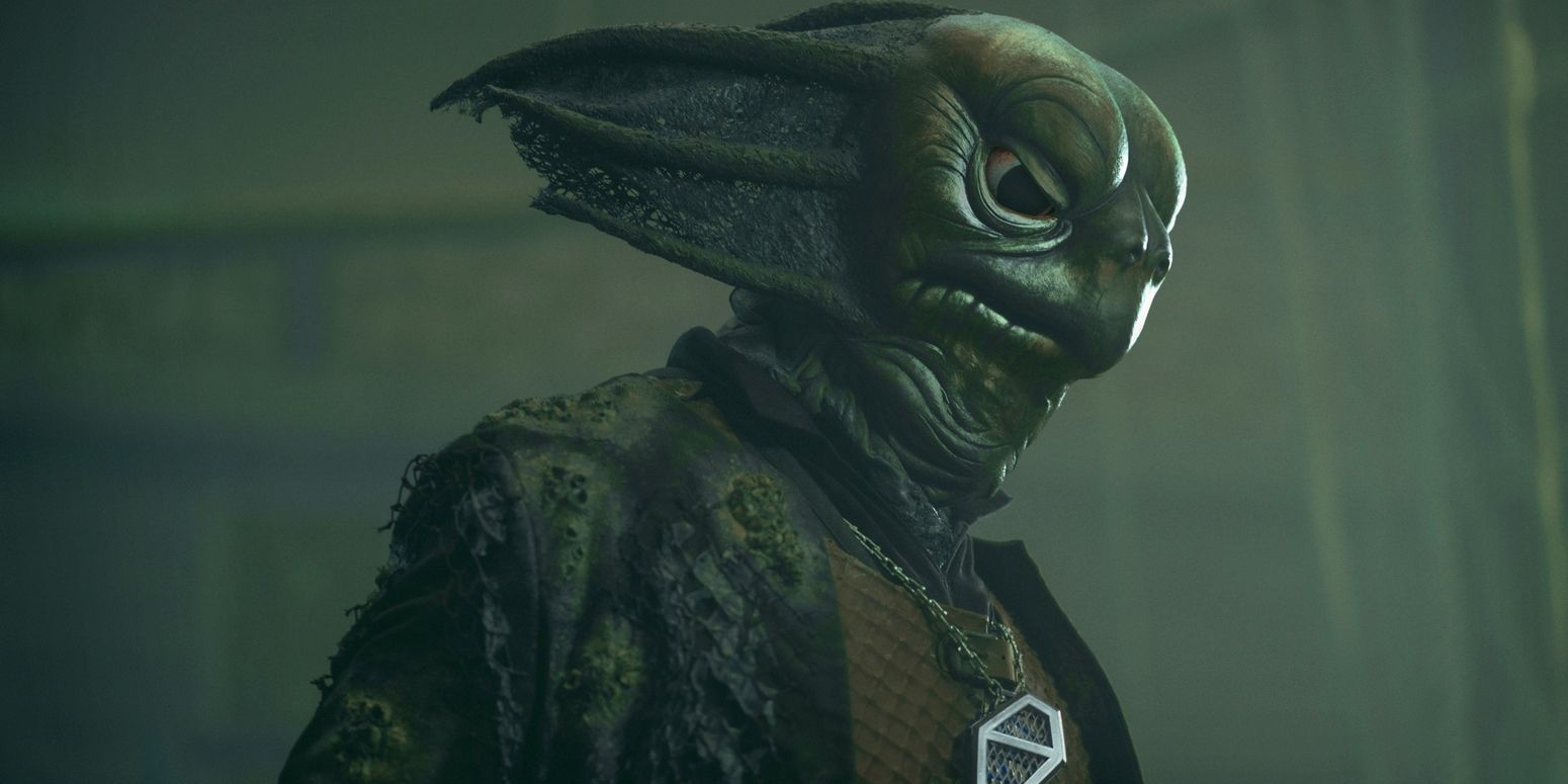 A Sea Devil looks down with a sad expression in Doctor Who