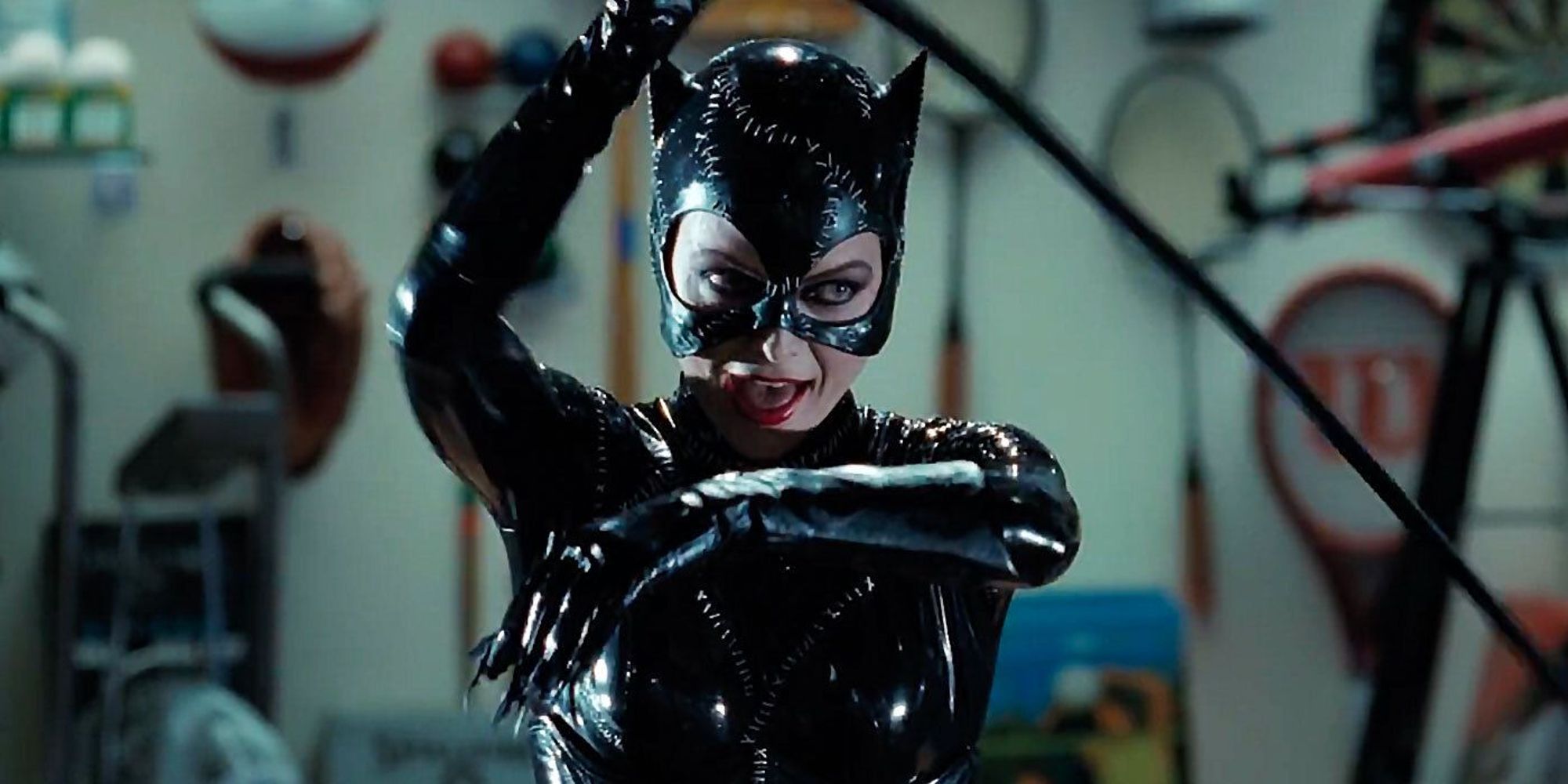 Michelle Pfeiffer as Catwoman wielding her whip in Shreck Plaza in Batman Returns