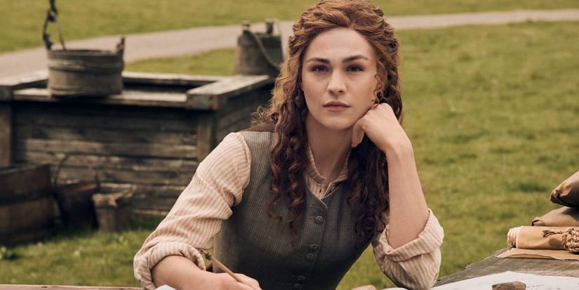 Bree sitting by a table in Outlander