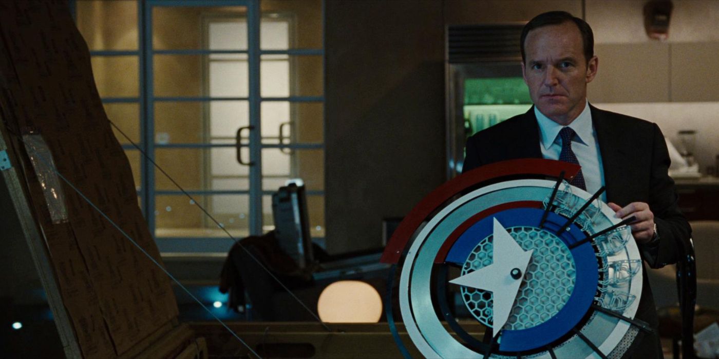 Phil Coulson holds a prototype of Captain Americas shield in Iron Man 2