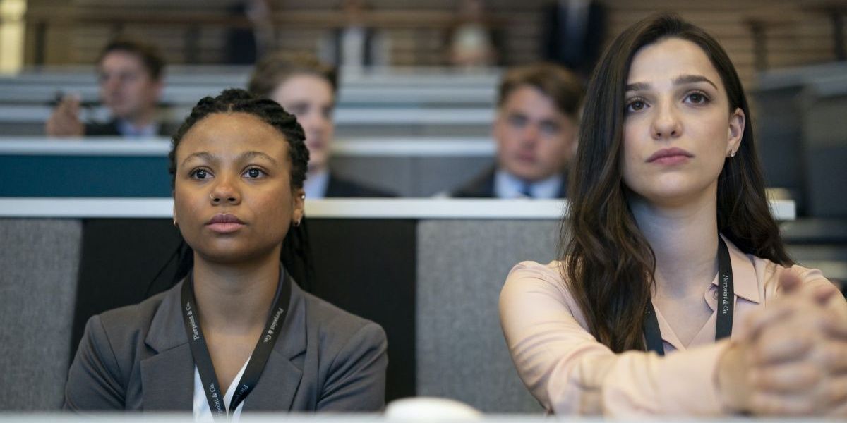 Two women sitting and attending a financial meeting in Industry Cropped