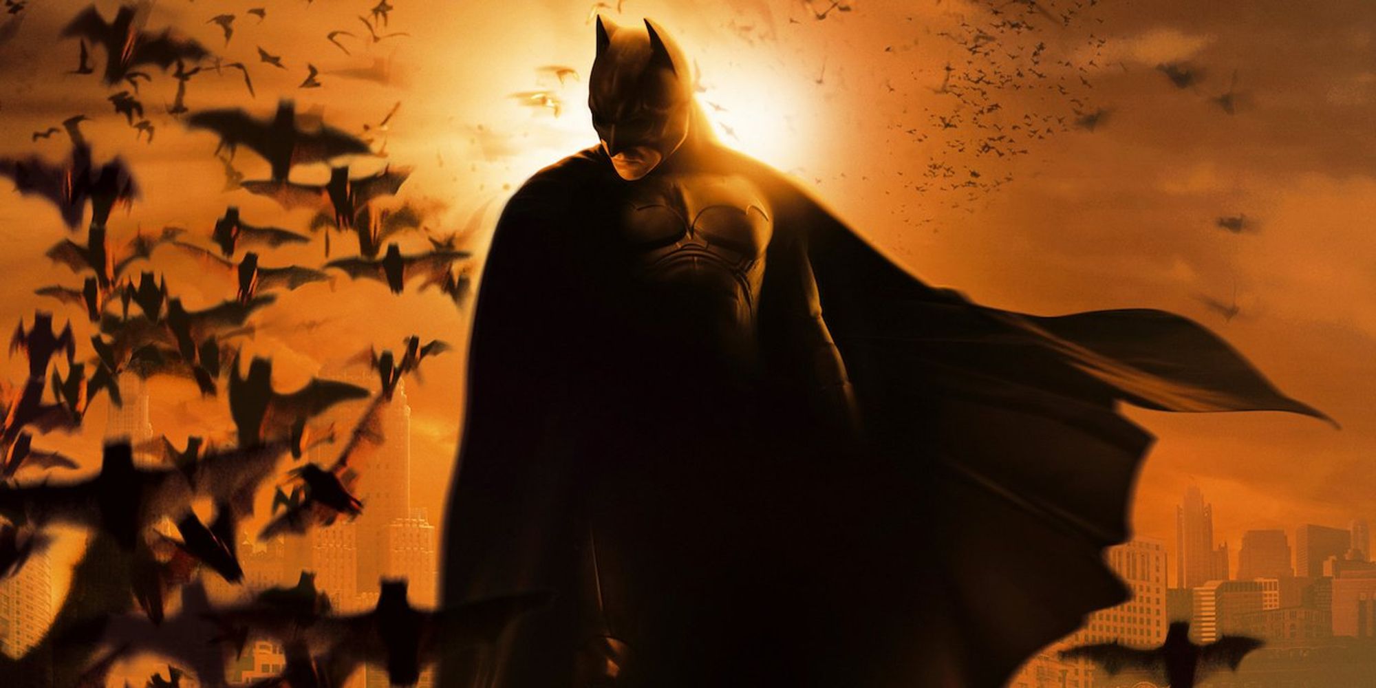 Batman overlooking Gotham with a swarm of bats in banner for Batman Begins