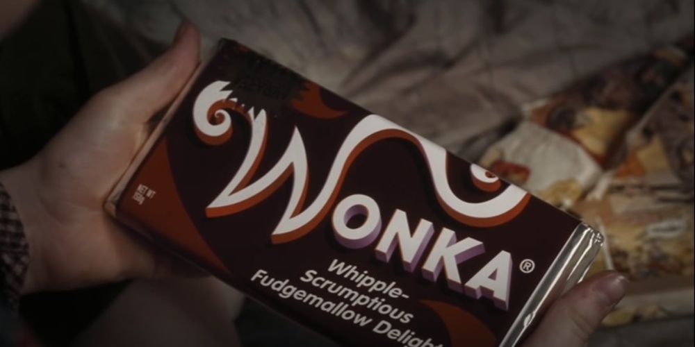 Charlie holds a Wonka Bar in Charlie and the Chocolate Factory Cropped 1