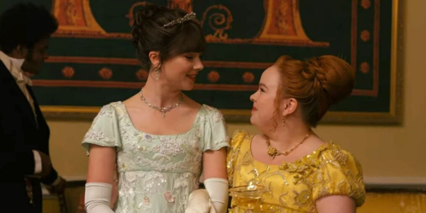 Eloise and Penelope talking at a ball on Bridgerton