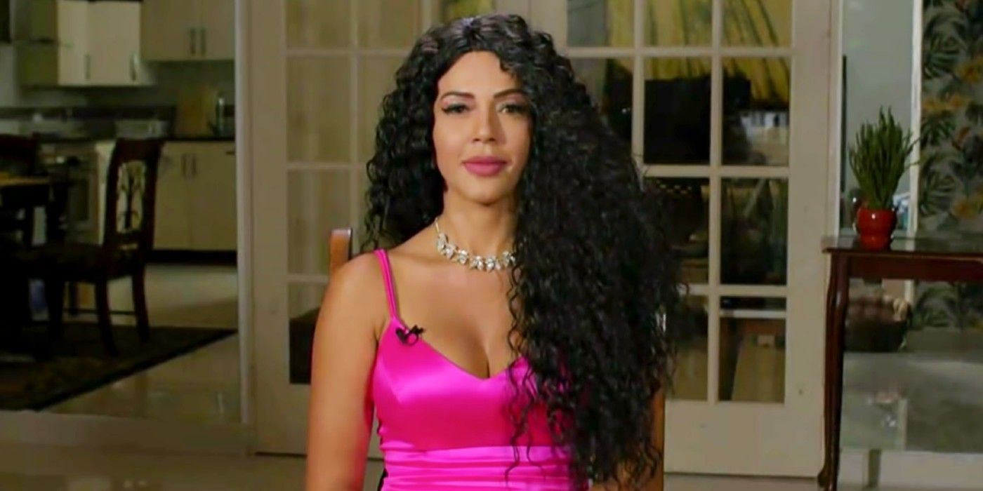 90 Day Fiance: Before the 90 Days Jasmine Pineda in pink dress, curly wig, smiling at Tell All