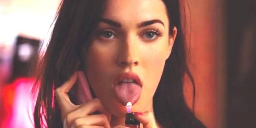 Megan Fox as Jennifer holds a lit flame up to her tongue in a scene from movie Jennifer's Body.