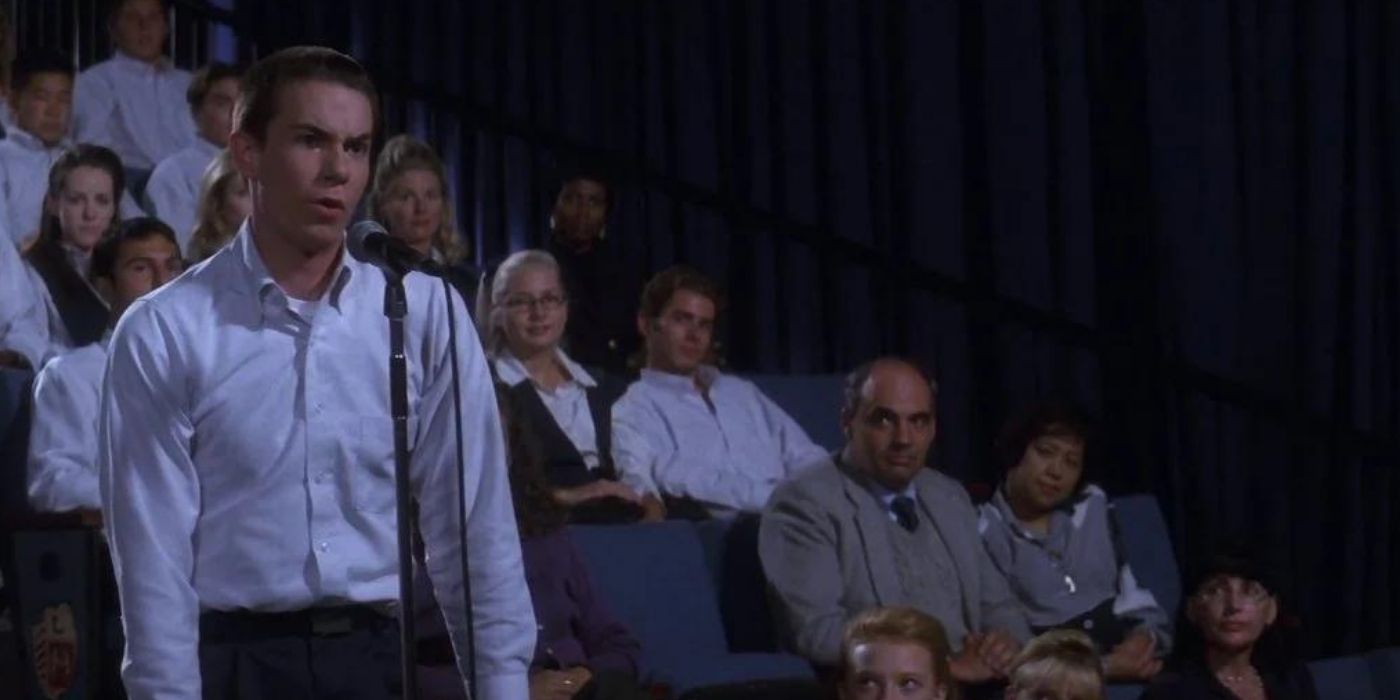 Jerry Trainor standing and speaking on a mic in Donnie Darko