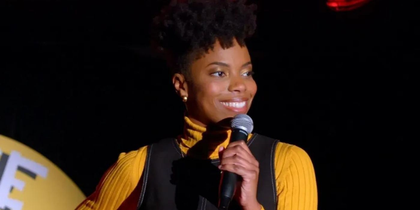 Sasheer Zamata holding a mic and smiling in Spree