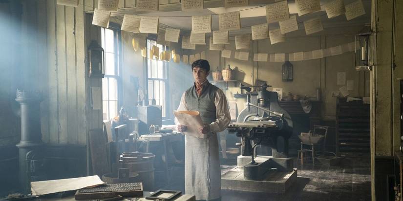 Theo standing in the printing shop on Bridgerton