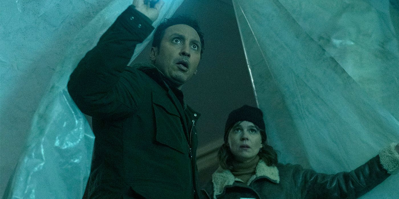 Aasif Mandvi and Katja Herbers go inside a tent and look astonished in Evil