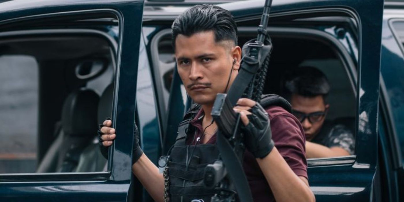 Harold Torres holding a gun and opening a car door in ZeroZeroZero