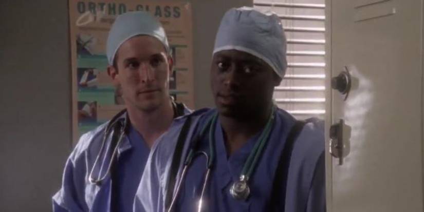 Dennis Grant standing in a doorway in ER.